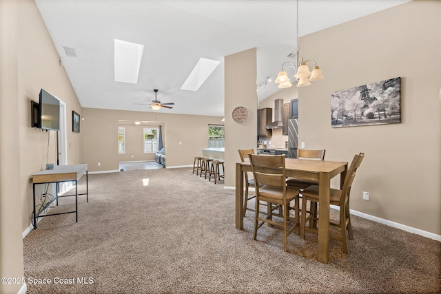 1265 Giralda Cir NW, Palm Bay, FL 32907 - carpeted dining room with a skylight, baseboards, ceiling fan, and high vaulted ceiling