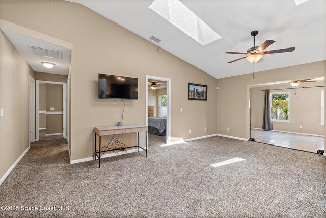 1265 Giralda Cir NW, Palm Bay, FL 32907 - unfurnished living room with a skylight, ceiling fan, carpet flooring, and vaulted ceiling