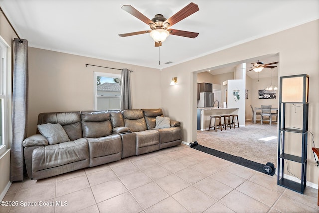 1265 Giralda Cir NW, Palm Bay, FL 32907 - living area featuring ceiling fan, light tile patterned floors, baseboards, crown molding, and light colored carpet