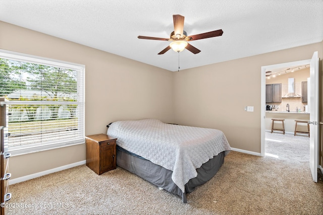 1265 Giralda Cir NW, Palm Bay, FL 32907 - bedroom with baseboards, light colored carpet, ceiling fan, and a textured ceiling