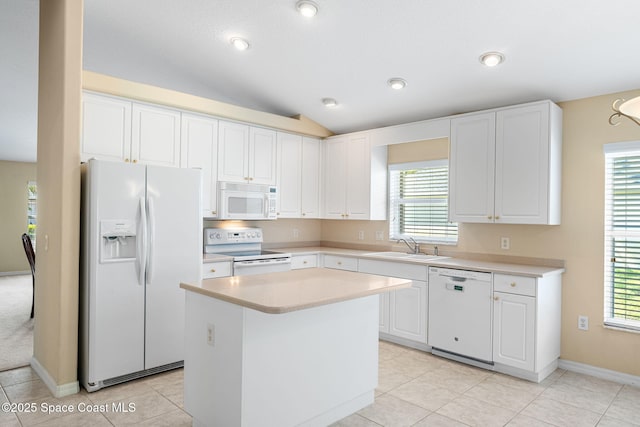 7175 Mendell Way, Melbourne, FL 32940 - kitchen with white appliances, white cabinetry, light countertops, a sink, and vaulted ceiling