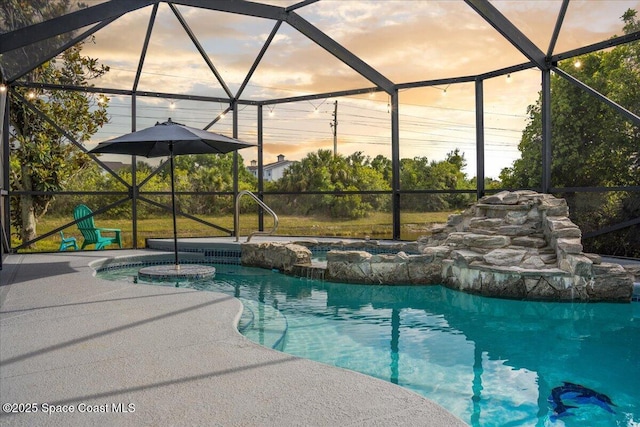 outdoor pool with glass enclosure, a patio, and an in-ground hot tub