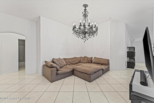 living area with a chandelier and light tile patterned floors