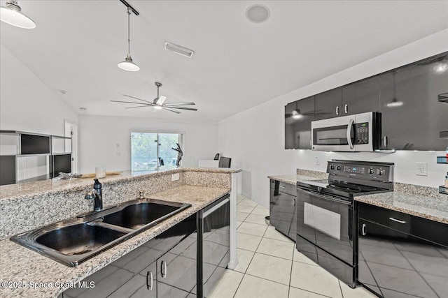 kitchen with stainless steel microwave, black range with electric cooktop, a sink, and dark cabinets