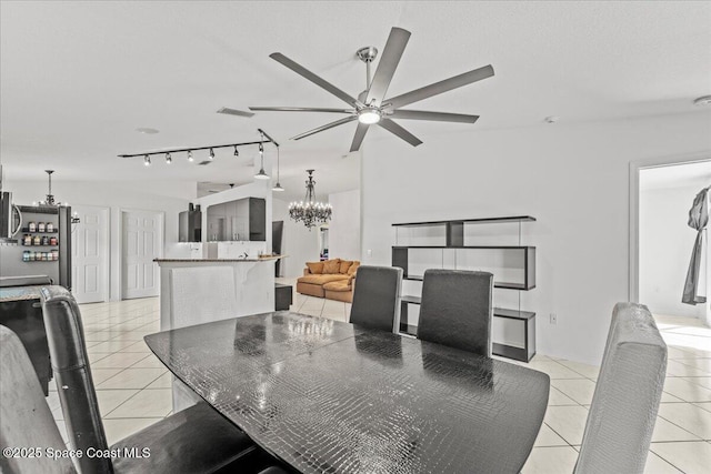 dining area featuring a chandelier, light tile patterned flooring, and ceiling fan