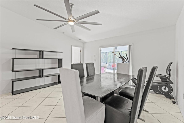 dining room with vaulted ceiling, a ceiling fan, and light tile patterned flooring