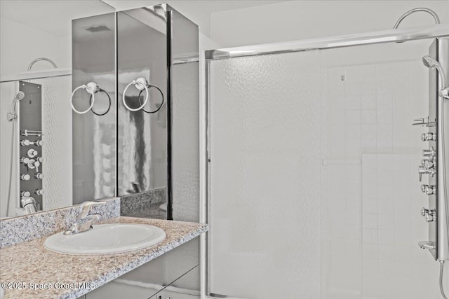 bathroom with a stall shower and vanity