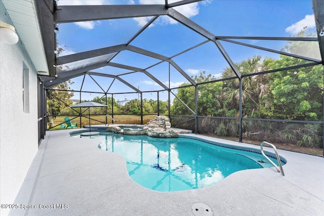 view of pool with a pool with connected hot tub, a patio, and glass enclosure