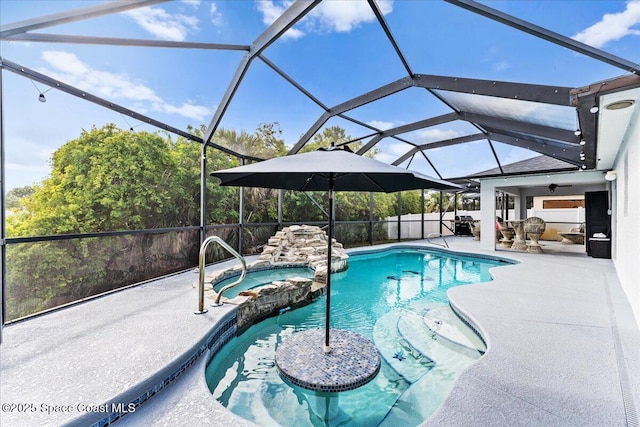 view of swimming pool with a patio area, a pool with connected hot tub, and a lanai