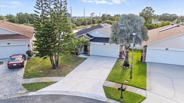 view of front facade with a front yard and concrete driveway