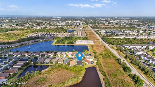 aerial view of property's location featuring nearby suburban area and a large body of water