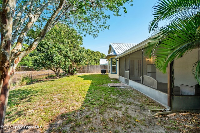 view of yard with a sunroom and french doors