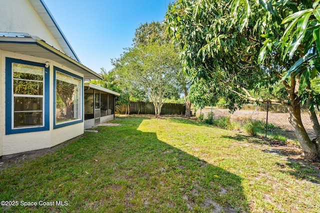 view of yard with a sunroom