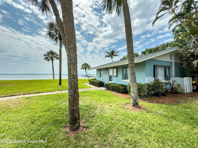 8 Cove Rd Unit 8-B, Melbourne Beach, FL 32951 - view of front of home with a front lawn, a water view, and stucco siding