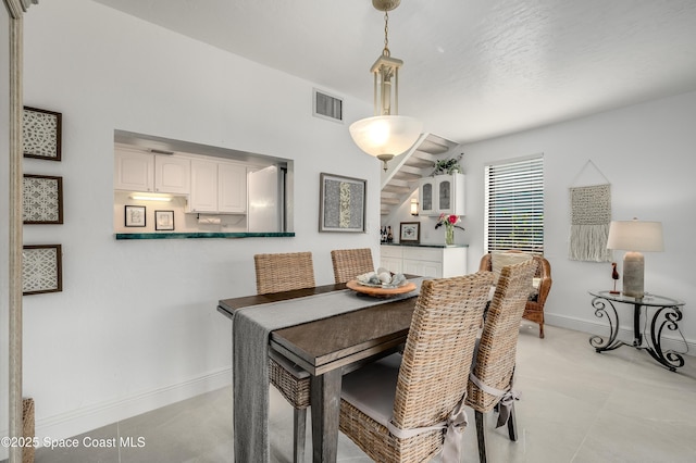 8 Cove Rd Unit 8-B, Melbourne Beach, FL 32951 - dining area featuring baseboards