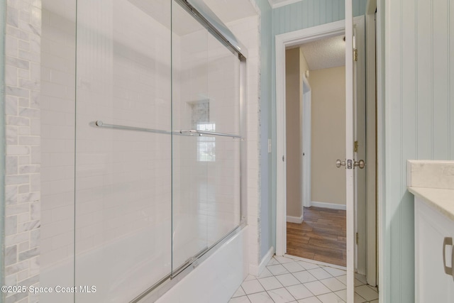 full bath featuring baseboards, tile patterned floors, and combined bath / shower with glass door