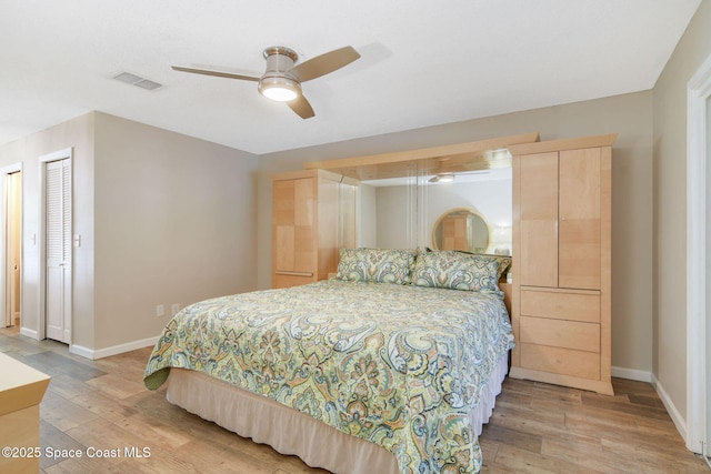 bedroom with light wood-type flooring, ceiling fan, baseboards, and visible vents
