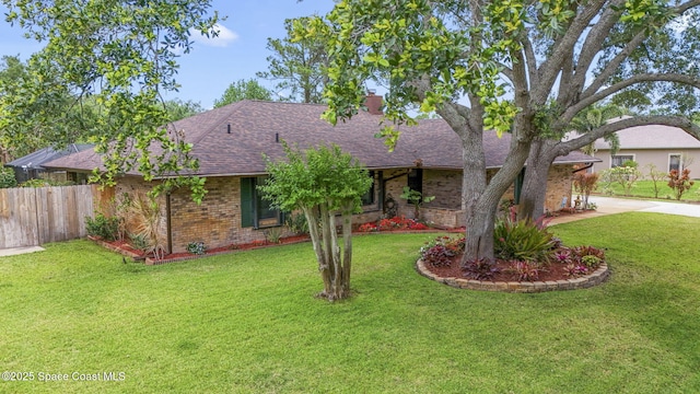 ranch-style house with brick siding, roof with shingles, and fence