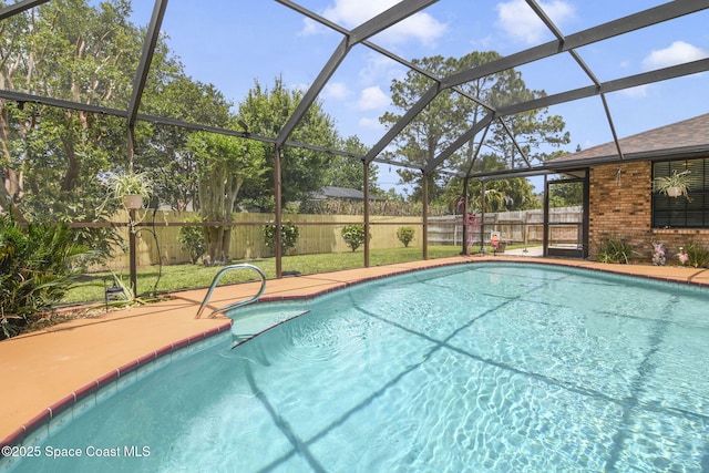 pool with a patio, a fenced backyard, and glass enclosure