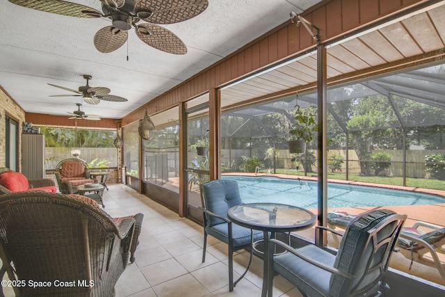 sunroom / solarium featuring ceiling fan and a pool