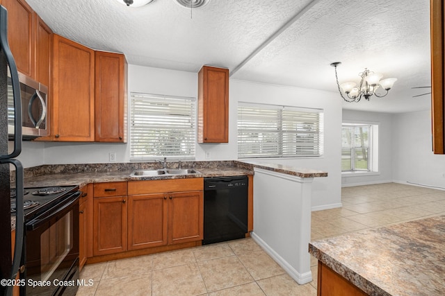 kitchen featuring black appliances, a sink, light tile patterned flooring, a textured ceiling, and brown cabinets