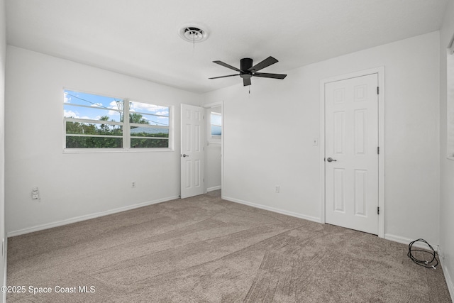 unfurnished bedroom with carpet floors, baseboards, and ceiling fan
