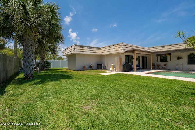 rear view of property featuring central AC, stucco siding, a patio, and mansard roof