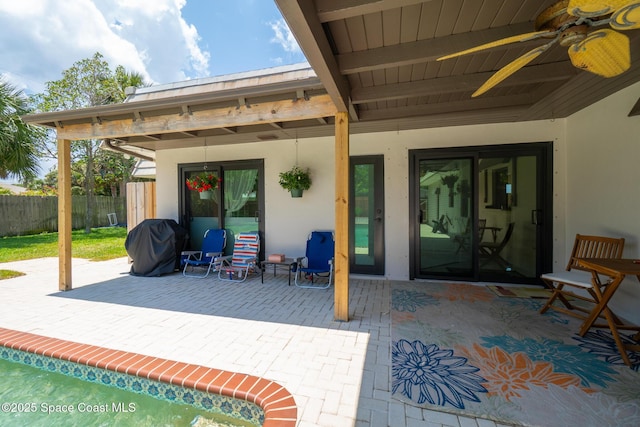 view of patio featuring fence, a ceiling fan, and a grill