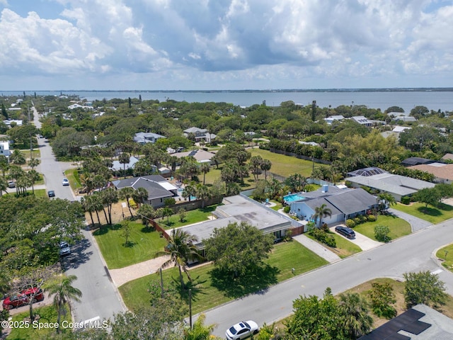 aerial view of residential area featuring a large body of water