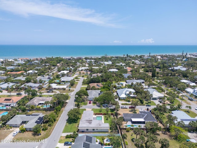 aerial view of residential area featuring a large body of water