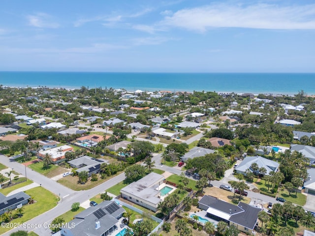 aerial view of residential area featuring a nearby body of water