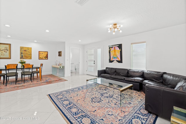 living area with recessed lighting, a chandelier, and baseboards