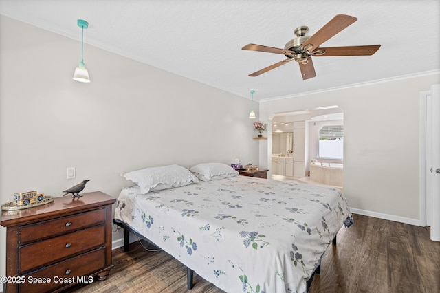 bedroom featuring wood finished floors, arched walkways, baseboards, ornamental molding, and ensuite bath