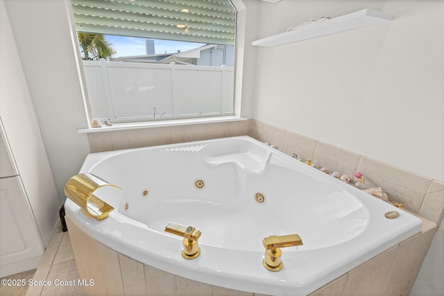 bathroom with a jetted tub and tile patterned floors
