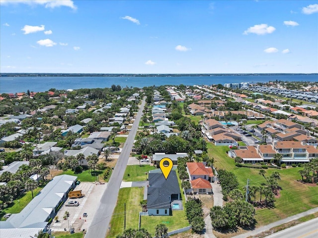 drone / aerial view featuring a water view and a residential view