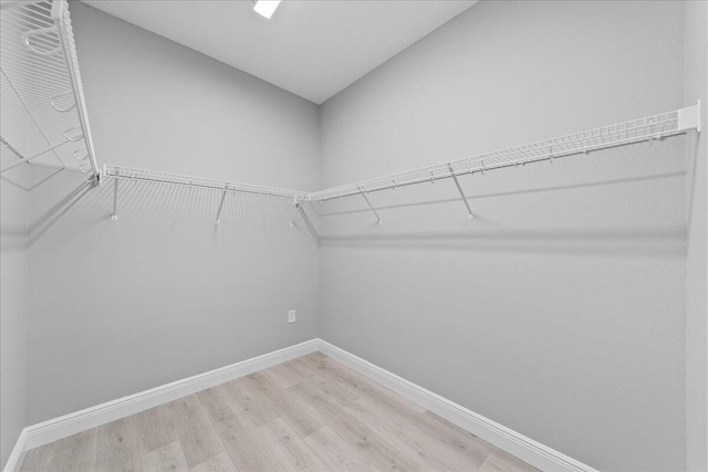 spacious closet with wood finished floors