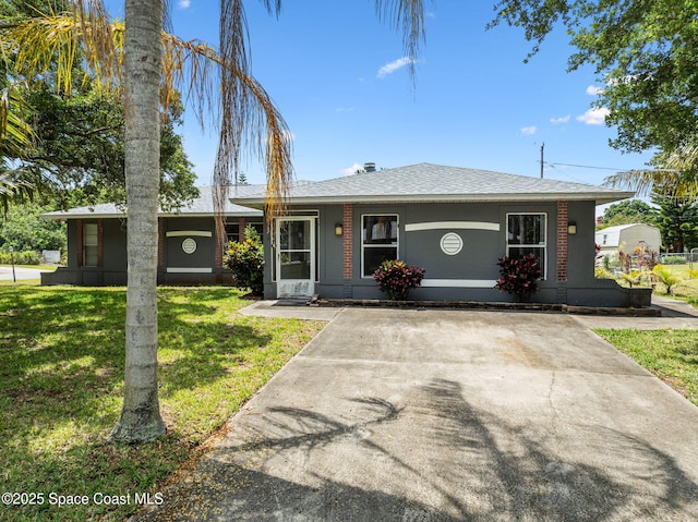 1554 Nona St NE, Palm Bay, FL 32907 - ranch-style home featuring a front lawn and a shingled roof