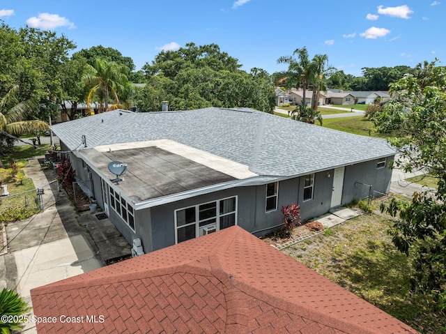 1554 Nona St NE, Palm Bay, FL 32907 - view of front of home with roof with shingles, fence, and stucco siding
