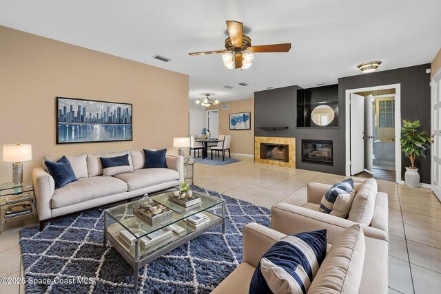 1554 Nona St NE, Palm Bay, FL 32907 - tiled living area with ceiling fan, a fireplace, and baseboards