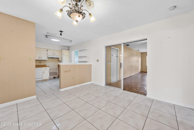 1554 Nona St NE, Palm Bay, FL 32907 - unfurnished room with a smoke detector, a textured ceiling, a chandelier, and baseboards