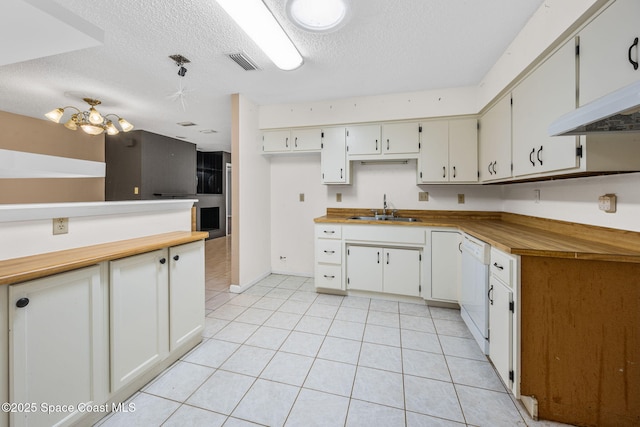1554 Nona St NE, Palm Bay, FL 32907 - kitchen featuring a sink, a textured ceiling, light tile patterned flooring, white dishwasher, and a chandelier