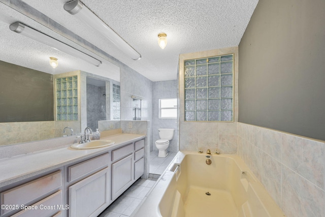 1554 Nona St NE, Palm Bay, FL 32907 - full bath with a textured ceiling, toilet, a bath, vanity, and tile walls