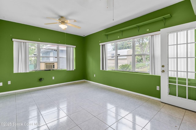 1554 Nona St NE, Palm Bay, FL 32907 - tiled empty room featuring ceiling fan, healthy amount of natural light, baseboards, and cooling unit