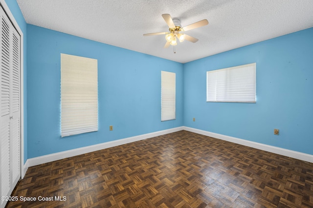 1554 Nona St NE, Palm Bay, FL 32907 - unfurnished bedroom with a closet, a textured ceiling, baseboards, and ceiling fan
