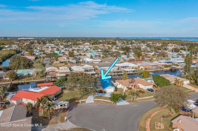 drone / aerial view with a water view and a residential view