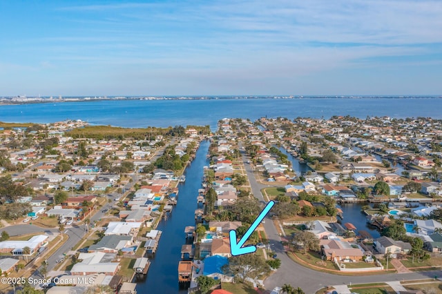drone / aerial view with a water view and a residential view