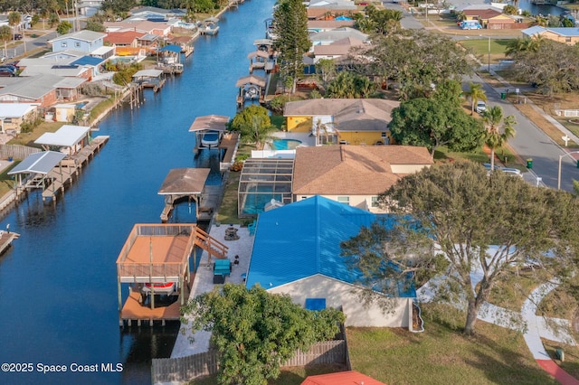 bird's eye view featuring a water view and a residential view