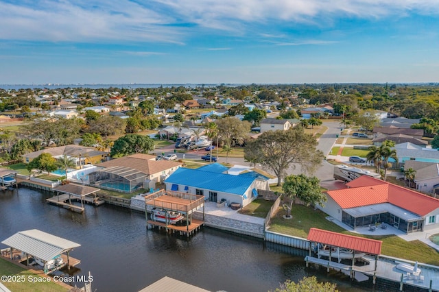birds eye view of property featuring a water view and a residential view