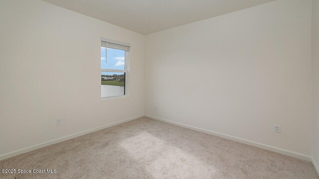 1276 Dugan Cir SE, Palm Bay, FL 32909 - empty room featuring baseboards and carpet floors