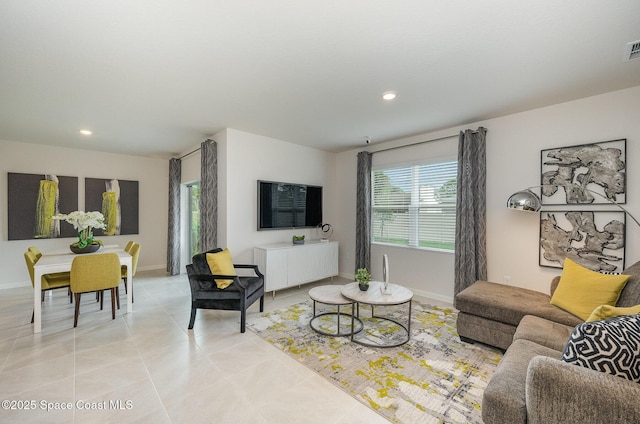 living room with light tile patterned floors, baseboards, visible vents, and recessed lighting